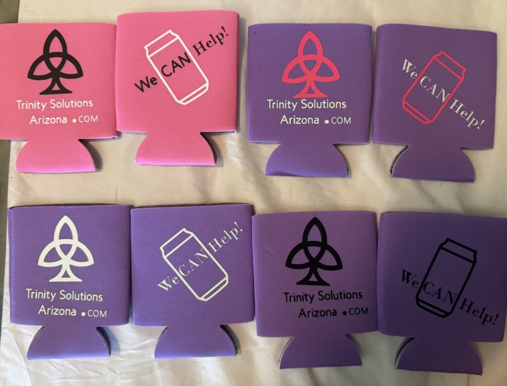 Pink and purple Trinity Solutions Arizona koozies printed with the trinity knot and We CAN Help
